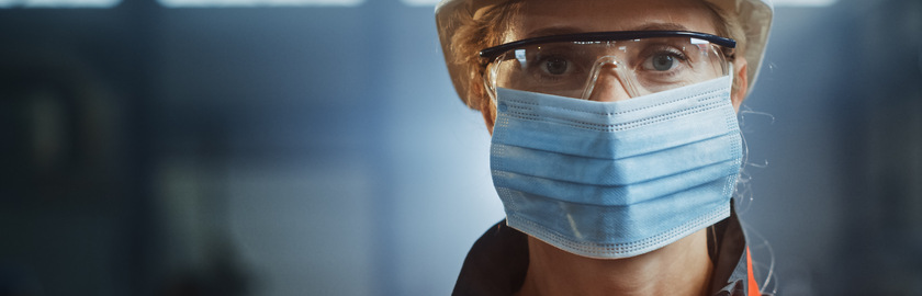 Portrait of a Professional Heavy Industry Engineer Worker Wearing on Safety Face Mask in a Steel Factory. Beautiful Female Industrial Specialist in Hard Hat Standing in Metal Construction Facility.