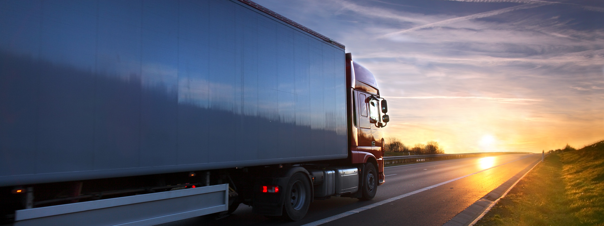 Truck transportation on the road at sunset