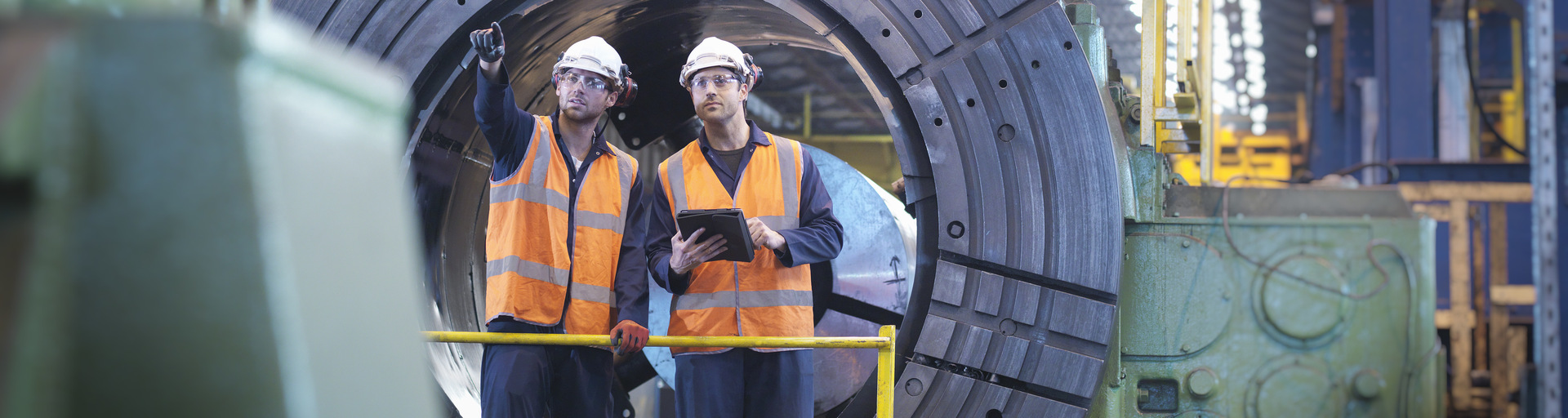 Engineers working together in engineering factory
