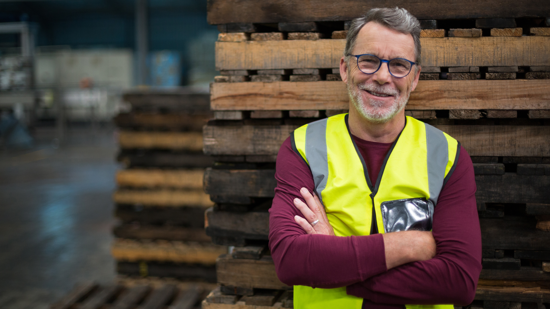 Portrait of male factory worker standing with arms crossed in drinks production factory