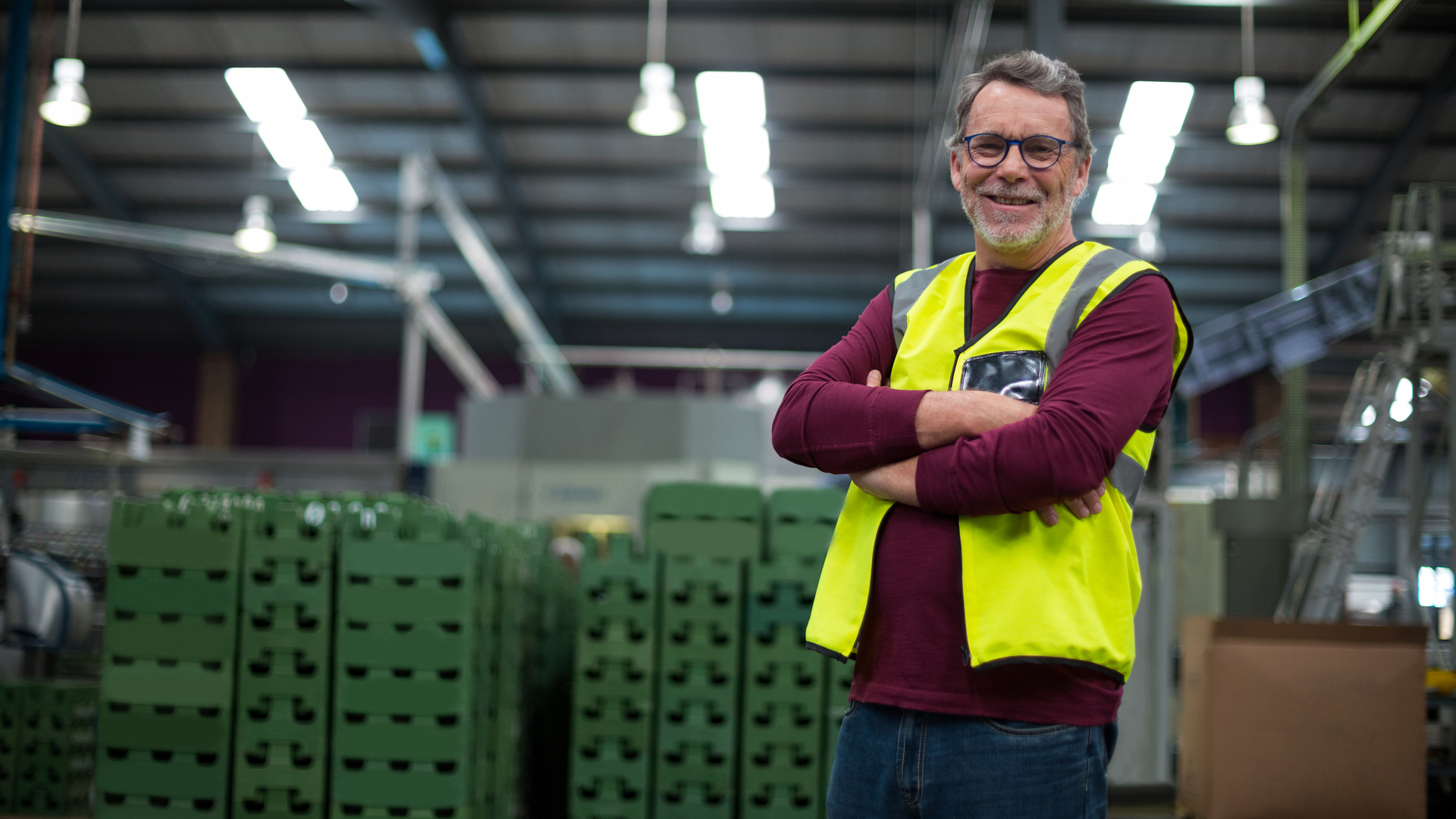 Portrait of male factory worker standing with arms crossed in drinks production factory